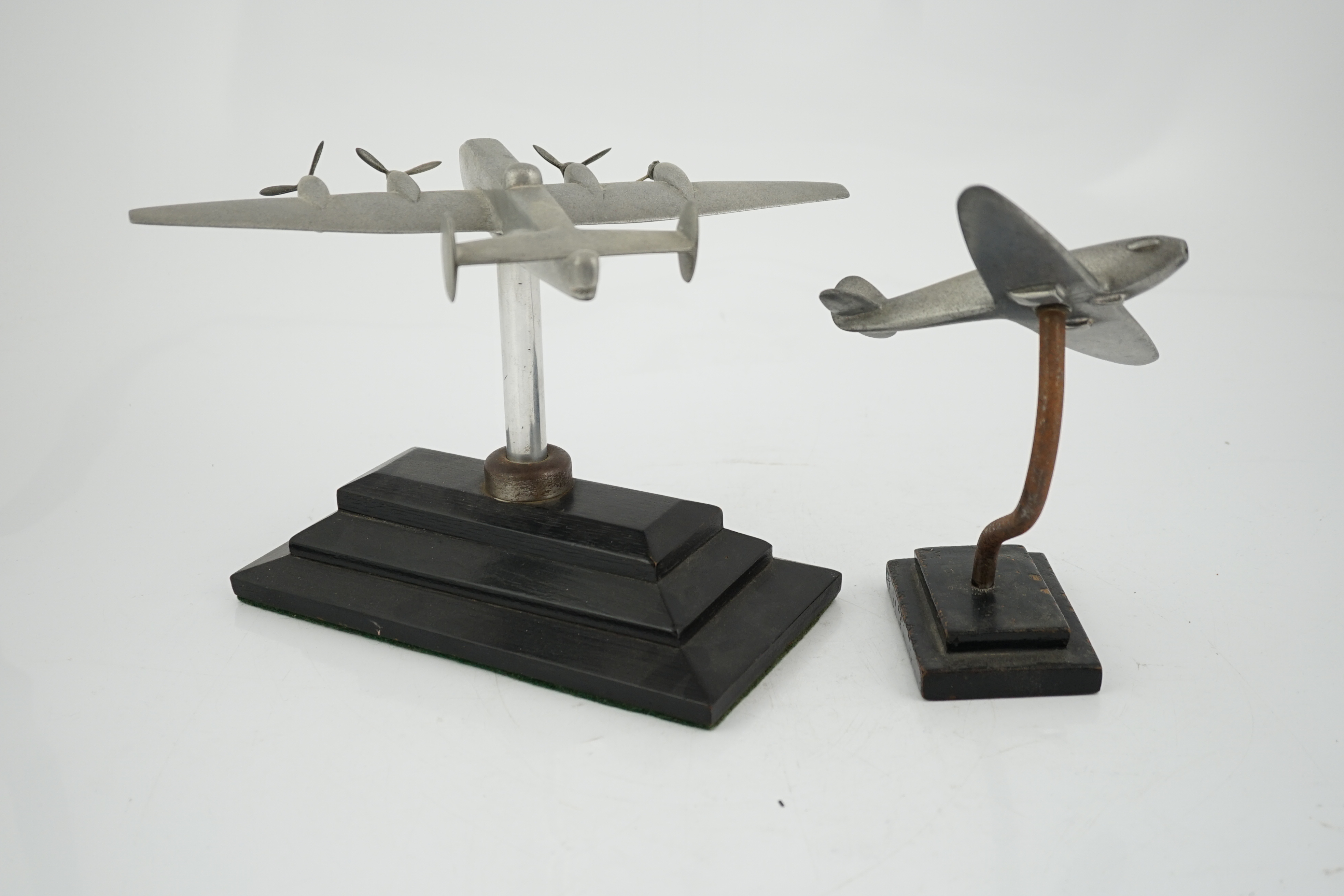 Two cast aluminium military aircraft models mounted on stepped wooden bases; a Halifax bomber, wingspan 30.5cm, and a Hawker Hurricane, wingspan 18cm